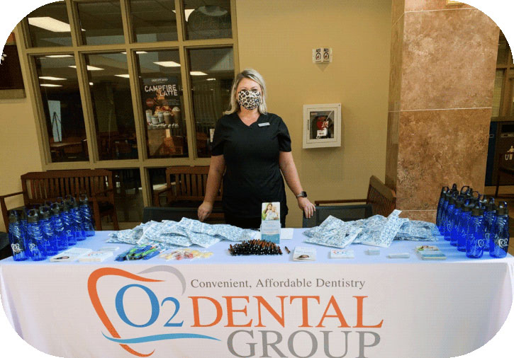 Picture of dental staff person wearing mask at a table