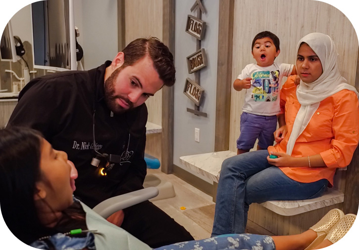Dentist doing oral examination on a pediatric patient