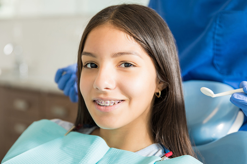 Girl wearing braces and smiling