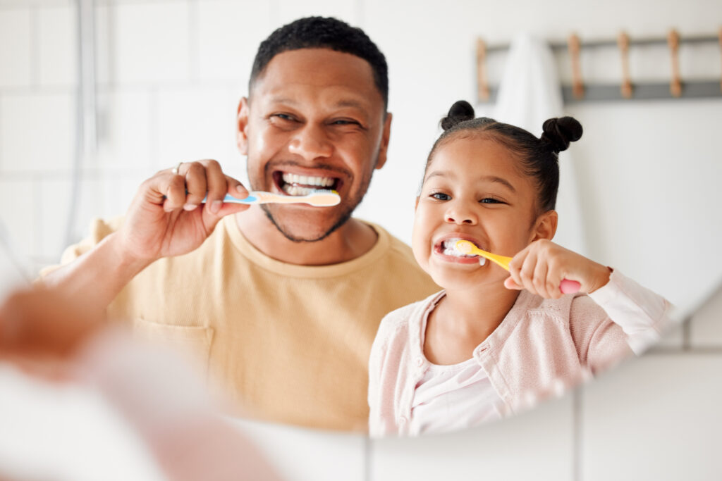 Child, dad and brushing teeth in a family home bathroom.